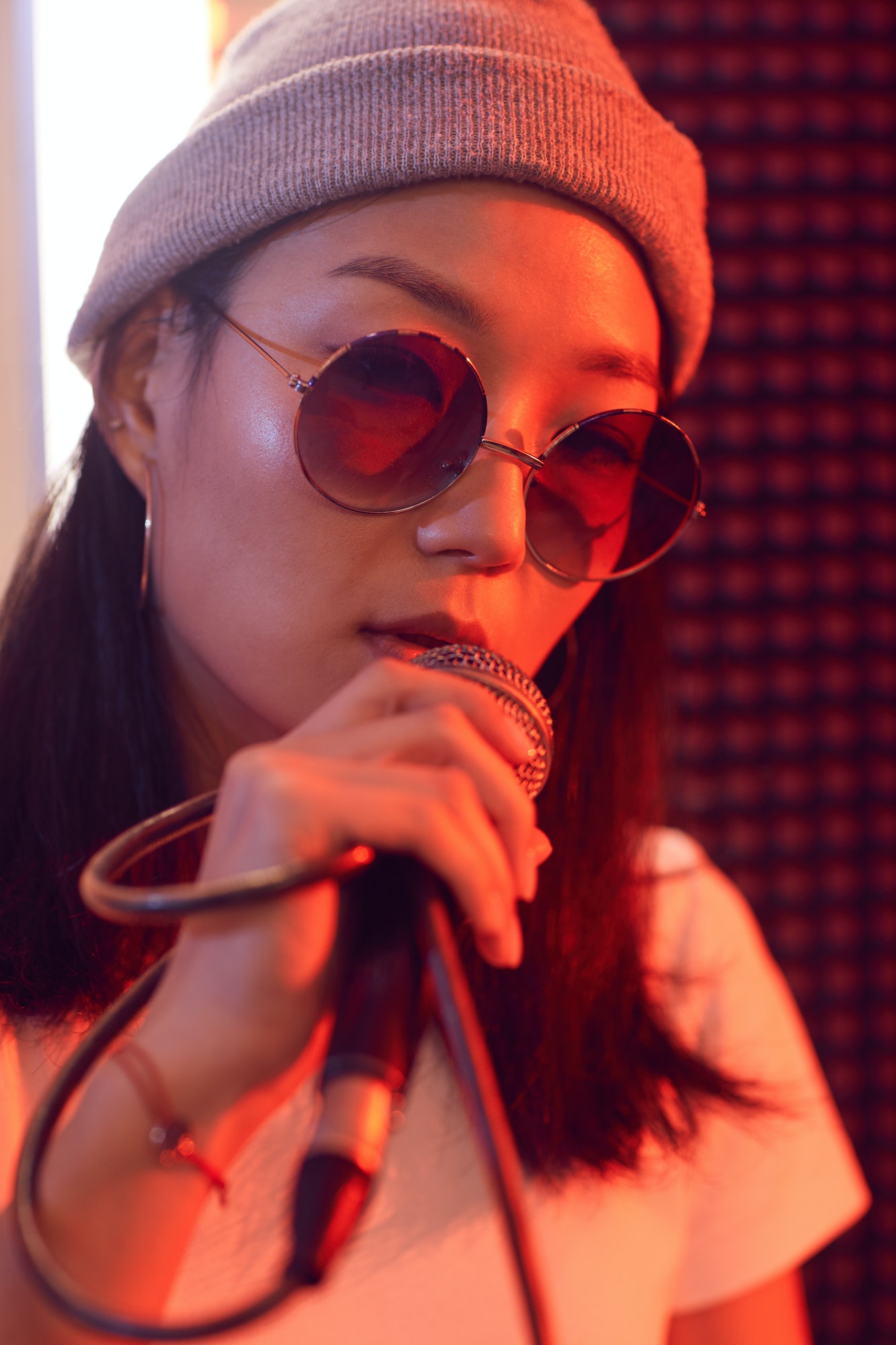 Contemporary Asian Woman Singing to Microphone